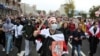 A young Belarusian protester, carrying a fake sword emblazoned with the word "Solidarity," marches with others in Minsk on September 27 to reject Belarus' official presidential election results and Alyaksandr Lukashenka's inauguration as president.