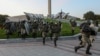  Riot police in Minsk's Hero City area rush to disperse protesters after Alyaksandr Lukashenka's September 23, 2020 inauguration.